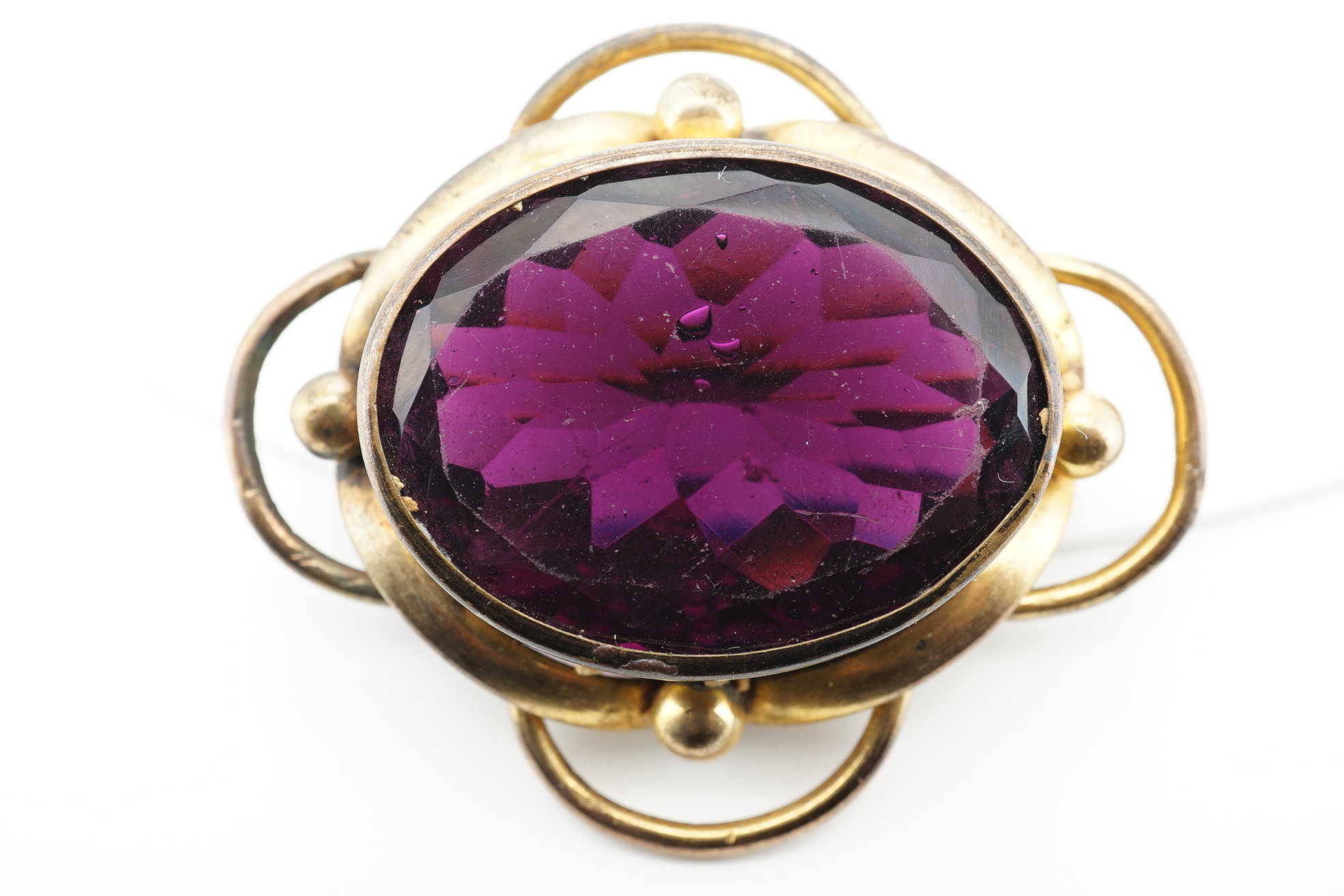 Two Victorian pinchbeck and amethyst paste set brooches, largest 62mm, together with three other items including a cameo shell brooch, tortoiseshell pique brooch and an agate mounted pill box. Condition - poor to fair